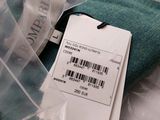 a close up of a green shirt with a price tag on it