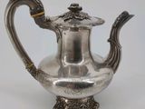 une théière ancienne en argent, munie d'une anse et d'un couvercle