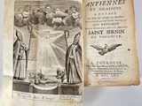 an old book with a picture of a woman holding a dove
