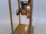 a gold clock that is sitting on a table