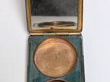 an image of a compact case with a mirror on top of it