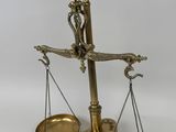an old brass scale with two scales on top of it