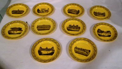 des assiettes jaunes ornées d'images en noir et blanc, posées sur une table
