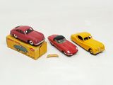 three toy cars that are sitting on top of a box