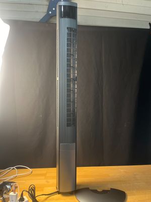 a fan that is sitting on a table next to a lamp