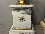 a white and gold clock with a star on it