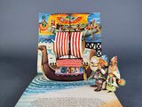 an open book with a picture of a pirate ship on top of it