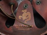 a close up of a metal object with a brown leather cover