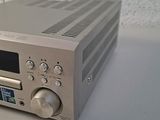 an image of a silver radio sitting on top of a white table