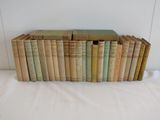 several old books stacked on top of each other on a white surface