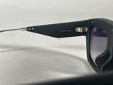 black sunglasses on a white table with a white background