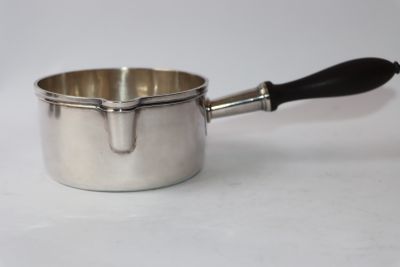 a silver sauce pot with a black handle on a white surface