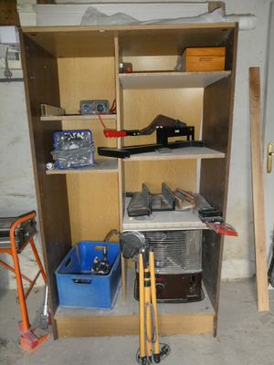 a shelf that has tools on it in a garage