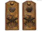 two metal plaques with a crown and a crown on them