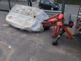 a car that is laying on the ground next to a tractor