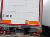 two trucks that are parked in a parking lot
