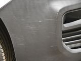 a close up of a car ' s front bumper and fender