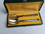 a silverware set in a black case on a white table