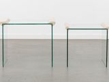 a pair of glass tables with a wooden top in a room