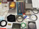 many different types of cameras and accessories laid out on a table
