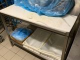 une table sur laquelle sont posés de nombreux sacs