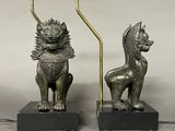 pair of antique bronze lions on marble bases with candles
