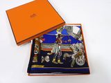 an orange box with a blue and orange scarf and a blue and orange box with a picture of a man on a horse
