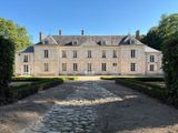 an image of a large house with a stone path in front of it