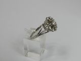 a close up of a silver ring on a clear stand