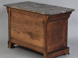 an old wooden chest with a marble top sitting on a gray surface