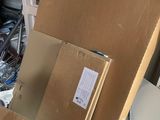 a cardboard box sitting on top of a pile of boxes