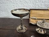 a silver plate with a spoon and spoon rest on a table