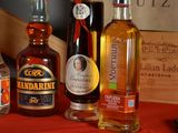 several bottles of alcohol are lined up on a red table
