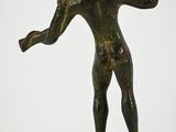 bronze statue of a boy holding a ball on a black base