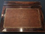 an old wooden desk with a brown leather top and gold trim