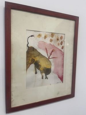 painting of a bull in a frame hanging on a wall