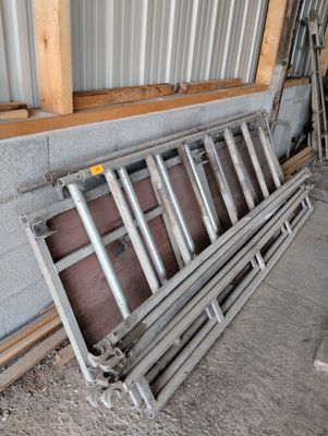 a pile of old metal and wood items in a building