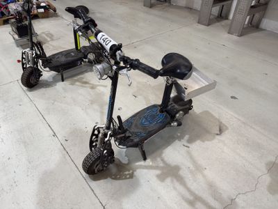 a scooter that is sitting on the floor in the garage