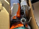 a cardboard box filled with assorted items in the back of a car