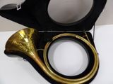 a black and gold horn sitting in a black case