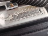a close up of a car ' s engine with a barcode on it