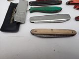 many different types of pocket knives on a table