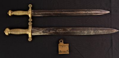 an image of a pair of old swords on a black background