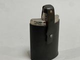 a lighter that is sitting on a white surface