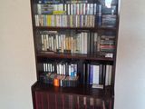 a book shelf with many books on it in a room