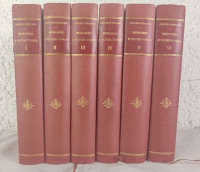six red books are lined up in a row on a table