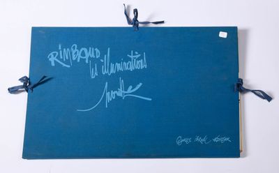 an old blue book with writing on it sitting on top of a table
