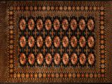a black and brown rug with a floral design on it