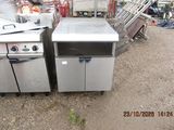 two stainless steel ovens sitting next to each other in a yard