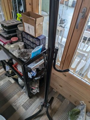 a small black cart with a bunch of items on it